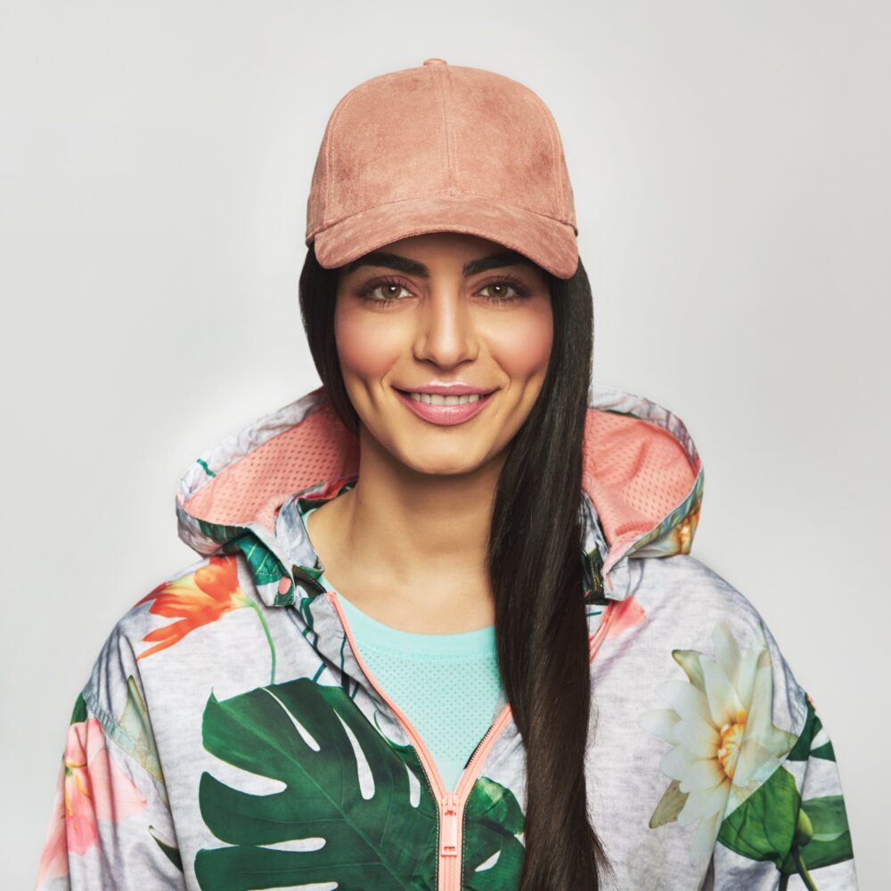 Pretty young woman in a peaked cap
